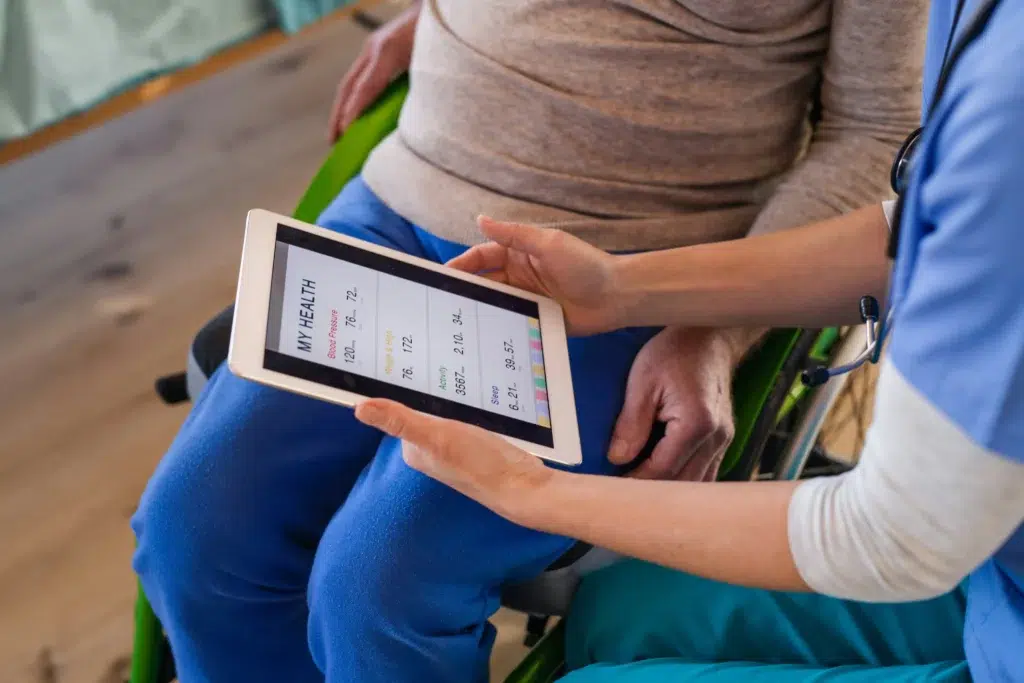 a doctor showing a patient charts on a tablet